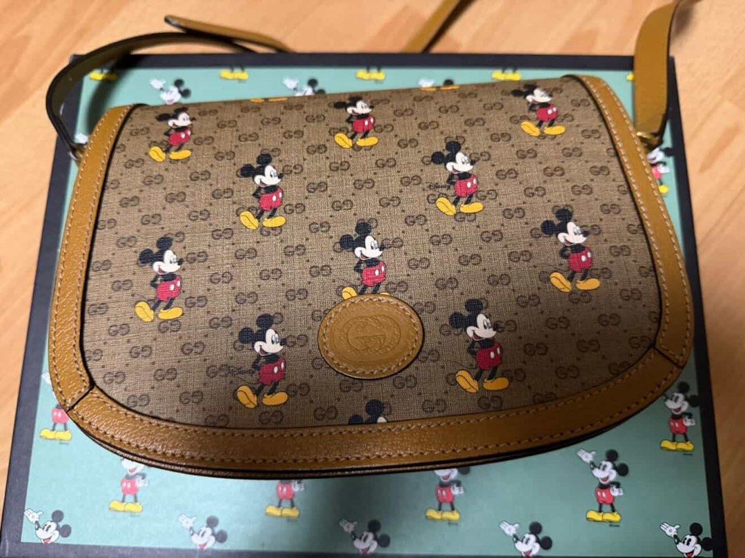 Gucci x Disney Mickey Mouse GG (Category: Cross-body Bags) located in Quezon City. Submitted by patriciahermo (Listing ID 1467267970, Image 2). Description: Authentic Gucci x Disney collaboration crossbody bag Iconic GG supreme canvas with playful Mickey Mouse print Premium brown leather trim and gold-tone hardware Adjustable shoulder/crossbody strap for comfort Clean interior lined in light fabric with a secure zip pocket Comes with the original