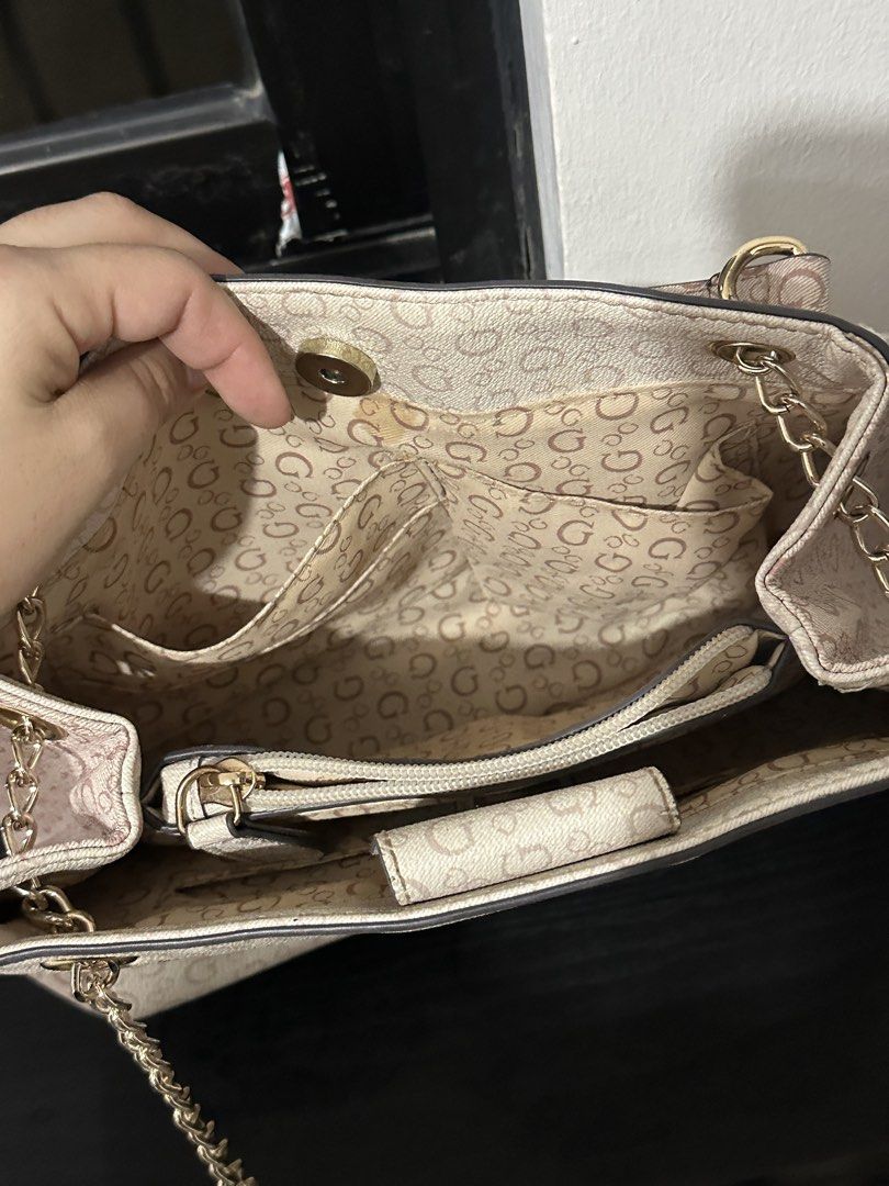 Guess Monogram Shoulder Bag with Chain Strap (Category: Shoulder Bags) located in Marikina City. Submitted by cheszam (Listing ID 1467203094, Image 3). Description: - Brand: Guess - Color: Off-white with monogram print - Hardware: Gold-tone - Strap: Chain strap included - Closure: Magnetic snap top closure - Interior: Multiple compartments, slip pockets, and a middle zip pocket with matching monogram lining - Branding: Metal Guess logo plaque on 