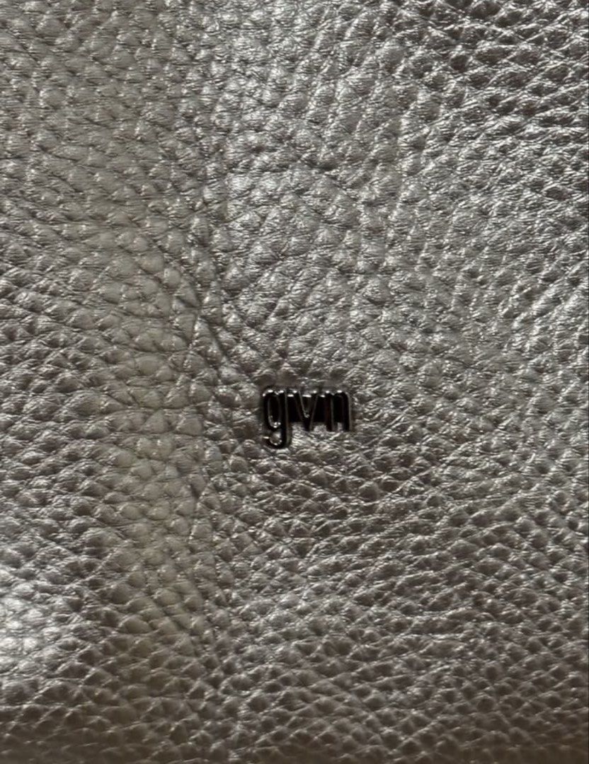 GVM Silver textured Metallic Shoulder Bag (Category: Shoulder Bags) located in Agdangan. Submitted by preloved_patch (Listing ID 1467292695, Image 3). Description: - Color & Finish: Silver metallic with a stylish pebbled texture - Closure: Secure top zip closure - Interior: Clean white lining with enough room for daily essentials - Details: Small GVM logo hardware on the front and a fun side charm - Style: Simple and versatile everyday shoulder b