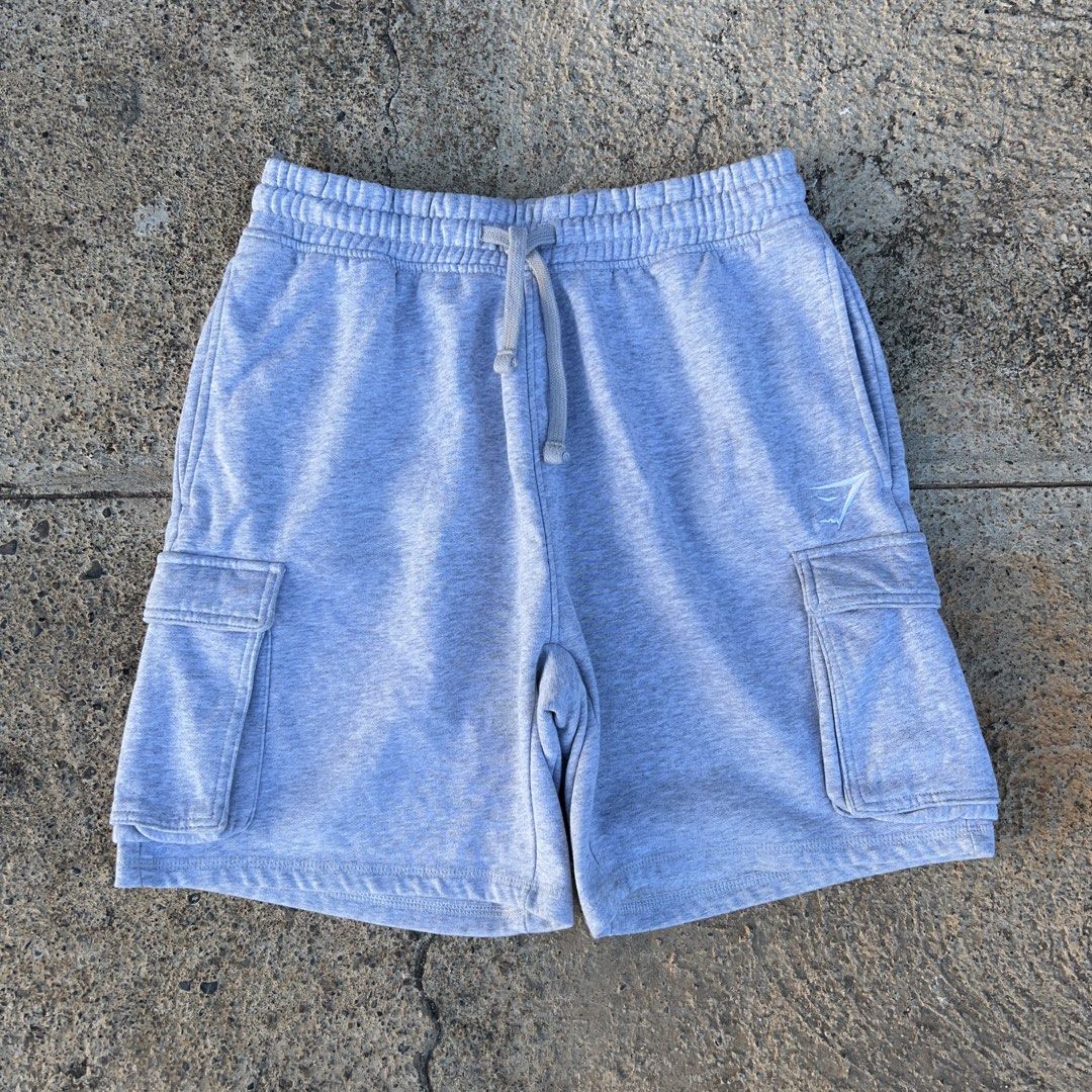 Gymshark Grey Cargo Sweat Shorts (Category: Shorts) located in Puerto Princesa. Submitted by jdthrifts (Listing ID 1467308070, Image 1). Description: Dimes Waist- 28-32 Length- 18 Hem- 11.