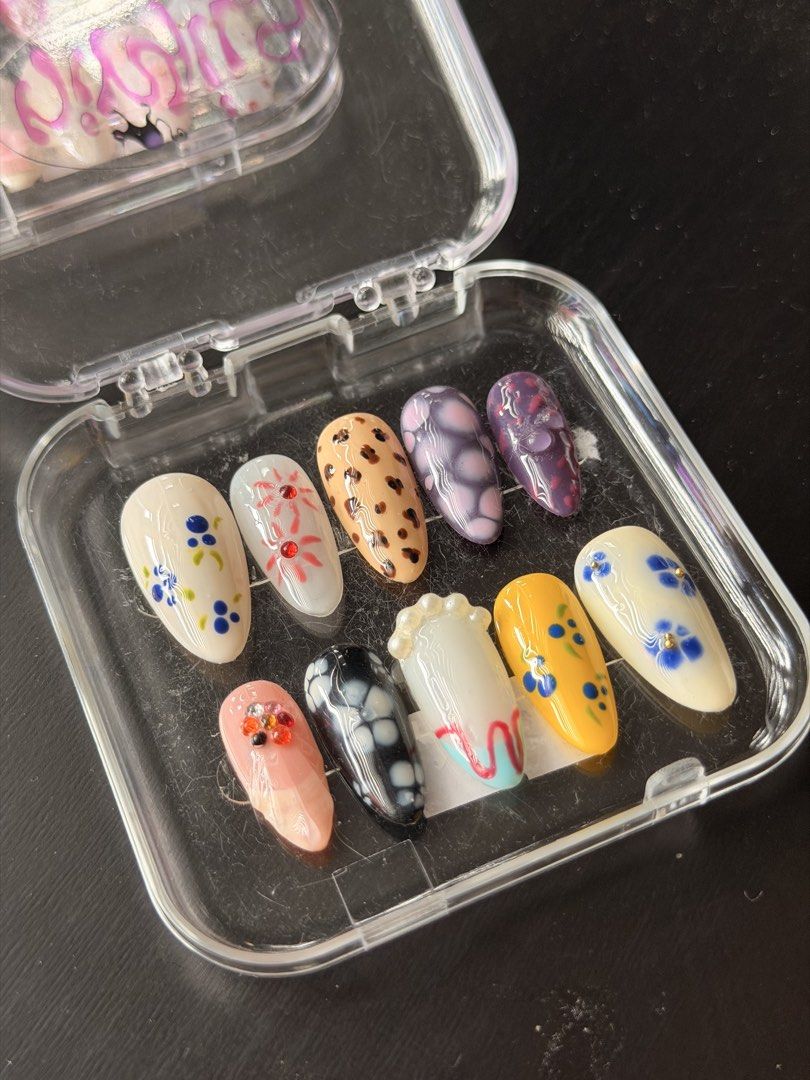 Handmade Press-On Nail Art Set Assorted Designs (SIZE L) (Category: Hands & Nails) located in Quezon City. Submitted by ninny.ph (Listing ID 1467190535, Image 2). Description: - Style: Floral, leopard print, and abstract art designs - Shape & Fit: Almond-shaped, set of 10 individual nails - Details: Enhanced with rhinestone and pearl accents - Condition: Brand new, never worn or used - Inclusions: Comes with a clear plastic storage case.