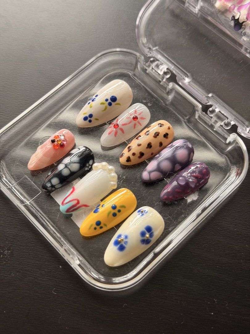 Handmade Press-On Nail Art Set Assorted Designs (SIZE L) (Category: Hands & Nails) located in Quezon City. Submitted by ninny.ph (Listing ID 1467190535, Image 1). Description: - Style: Floral, leopard print, and abstract art designs - Shape & Fit: Almond-shaped, set of 10 individual nails - Details: Enhanced with rhinestone and pearl accents - Condition: Brand new, never worn or used - Inclusions: Comes with a clear plastic storage case.