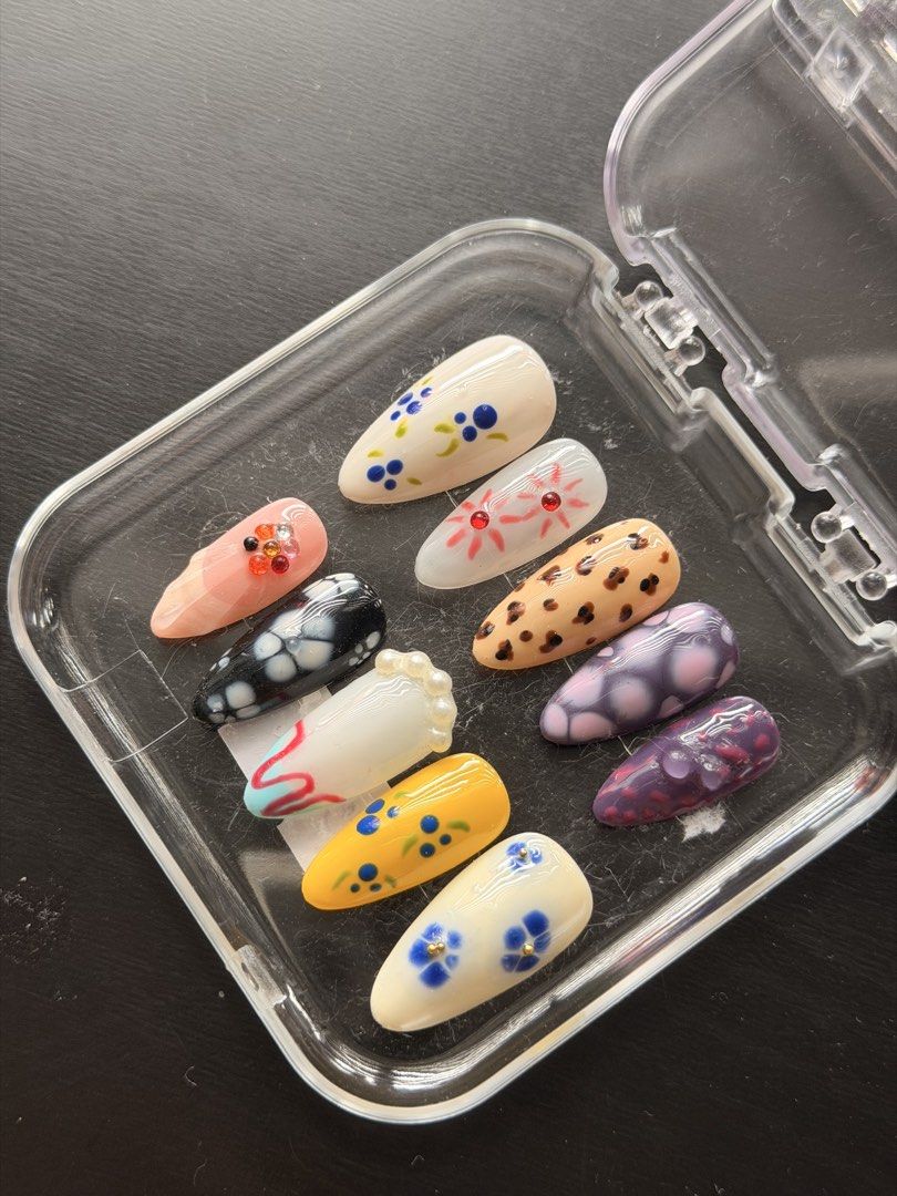 Handmade Press-On Nail Art Set Assorted Designs (SIZE L) (Category: Hands & Nails) located in Quezon City. Submitted by ninny.ph (Listing ID 1467190535, Image 3). Description: - Style: Floral, leopard print, and abstract art designs - Shape & Fit: Almond-shaped, set of 10 individual nails - Details: Enhanced with rhinestone and pearl accents - Condition: Brand new, never worn or used - Inclusions: Comes with a clear plastic storage case.