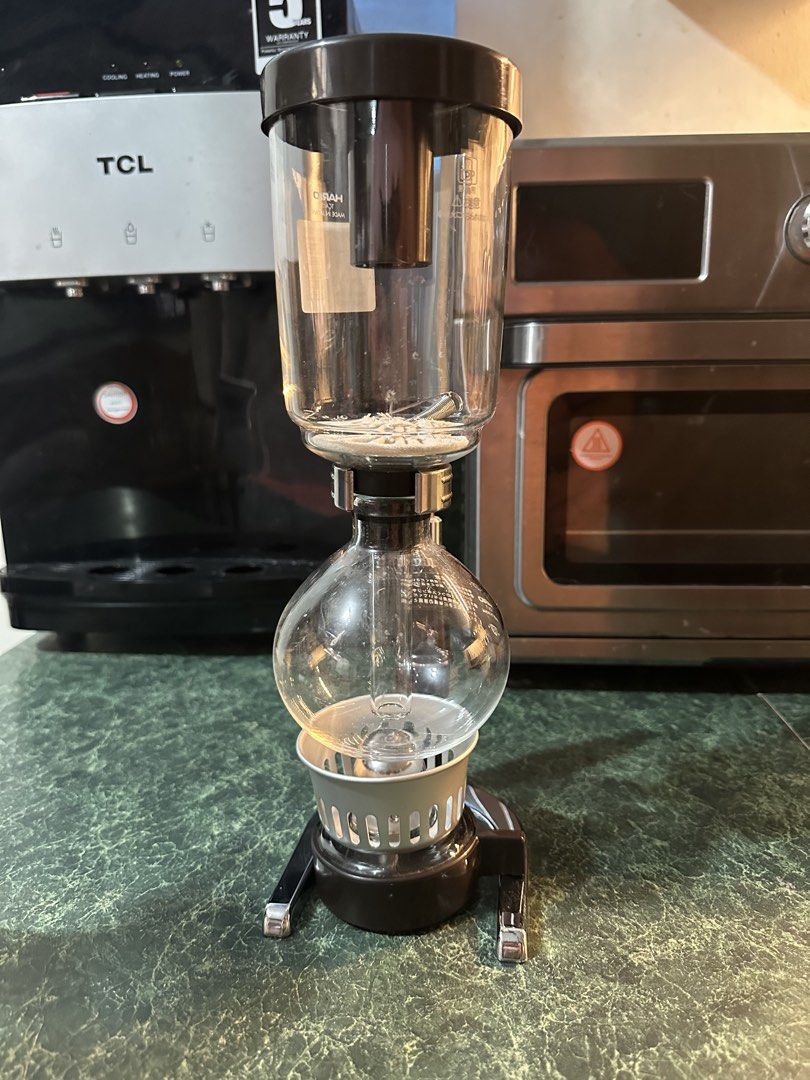 Hario TCA-3 Syphon Coffee Maker (Category: Coffee Machines & Makers) located in Manila. Submitted by olxph_561736521 (Listing ID 1467351188, Image 1). Description: - Authentic Hario TCA-3 coffee syphon, made in Japan - Includes original Japanese sticker on the upper glass cylinder - Clean glass chambers with a sleek black stand and handle - Comes complete with filter and metal spring inside the upper bowl - Pristine condition and ready to brew.