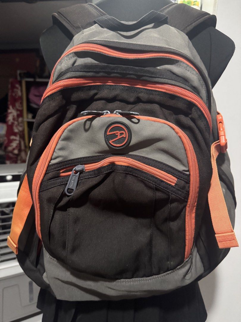 Hawk backpack grey orange multi-compartment travel school bag (Category: Backpacks) located in Manila. Submitted by sheinevida (Listing ID 1467269639, Image 1). Description: discoloration hence selling cheap - Brand: Hawk - Colorway: Grey and orange - Exterior: Multiple zipped front compartments and secure side buckle straps - Interior: Built-in organizers, key hook clip, and mesh pockets - Condition Notes: Sturdy, fully functioning zippers and a