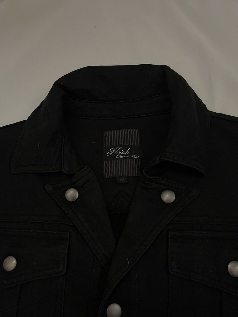 Heist Premium Label Black Jacket (Category: Coats, Jackets and Outerwear) located in Paranaque City. Submitted by laichii00 (Listing ID 1467348568, Image 2). Description: - Brand: Heist Premium Label - Color: Black - Closure: Front button with metallic snap buttons - Pockets: Dual chest flap pockets, side slip pockets, and a zipped left sleeve utility pocket.