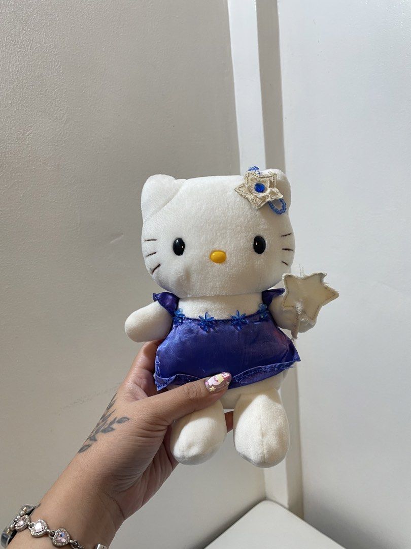 Hello Kitty Eikoh Magical Star Blue Dress Plush (Category: Plushies & Soft Toys) located in Iba. Submitted by wealtheallymari99 (Listing ID 1467268572, Image 1). Description: - Authentic Eikoh Kitty plush doll, direct from Japan - Dressed in a shiny blue satin gown with floral bead neckline accents - Matching star headpiece with a blue gem and a cute fabric star wand in hand - Soft white plush body featuring neat black embroidered eyes and whiske
