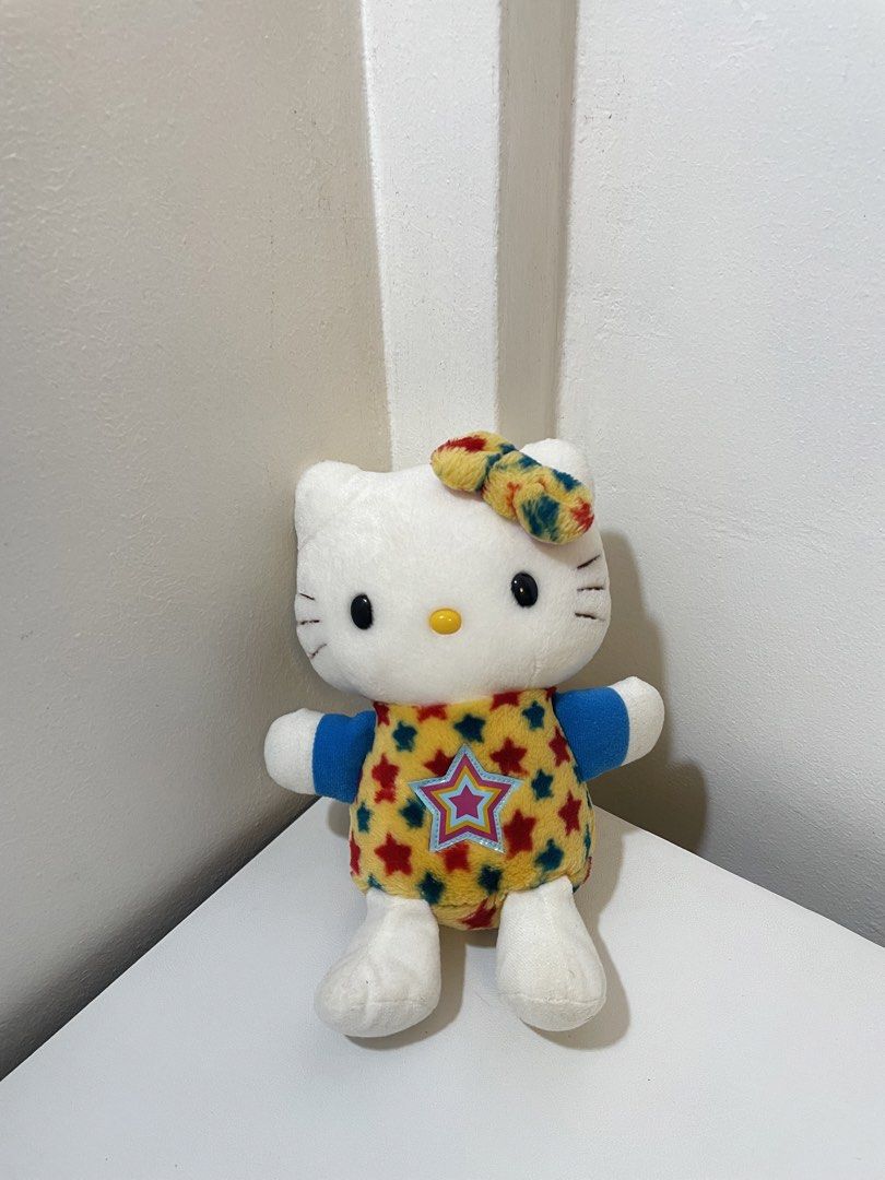 Hello Kitty Eikoh Star Outfit Plush Toy (Category: Plushies & Soft Toys) located in Iba. Submitted by wealtheallymari99 (Listing ID 1467269245, Image 1). Description: - Adorable yellow romper with red and blue star prints and matching hair bow - Features a large star patch on the front - Made with soft, huggable plush fabric - Clean white face and paws - Perfect for gifts, Sanrio fans, and plush collectors - Ships securely and fast.