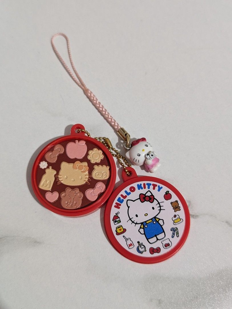 Hello Kitty Sanrio Round Compact Charm Strap (Category: Character Goods) located in Abucay. Submitted by nyannner (Listing ID 1467340581, Image 1). Description: - Adorable Kitty design with a pink strap and tiny camera - Features double-sided fun: Kitty graphics on one side, molded cookies in a tray on the other - Attached with stylish golden chains - Versatile accessory for bags, keys, or lanyards - Ships fast within the Philippines.