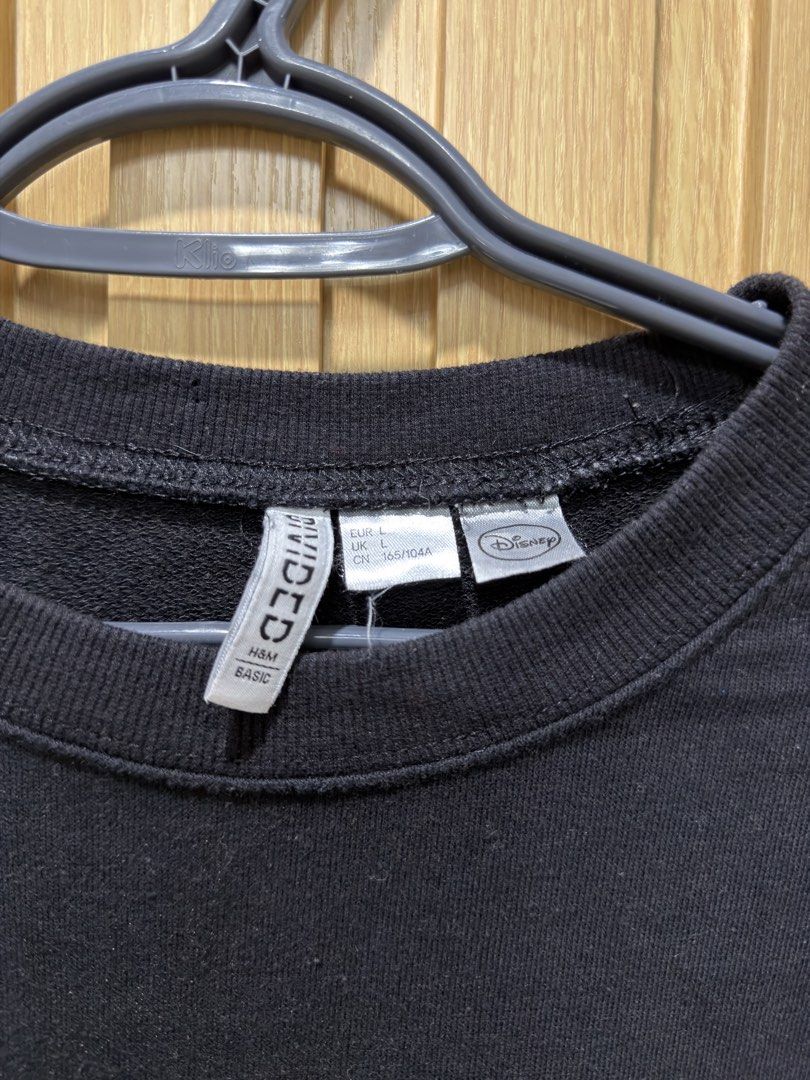 H&M Divided Disney Mickey Mouse Black Sweatshirt (Category: Coats, Jackets and Outerwear) located in Bacoor. Submitted by preloved_with_love_ (Listing ID 1467335025, Image 3). Description: - Brand: H&M Divided x Disney - Color: Black - Design: Minimalist white Mickey Mouse ear silhouette embroidered on the left chest - Material: 50% cotton, 50% polyester blend - Details: Ribbed collar, cuffs, and hem - Size: EUR L, UK L, CN 165/104A - Measurement