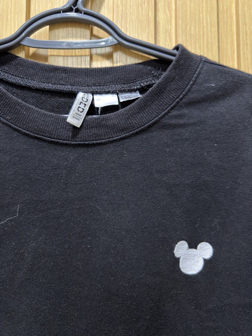 H&M Divided Disney Mickey Mouse Black Sweatshirt (Category: Coats, Jackets and Outerwear) located in Bacoor. Submitted by preloved_with_love_ (Listing ID 1467335025, Image 2). Description: - Brand: H&M Divided x Disney - Color: Black - Design: Minimalist white Mickey Mouse ear silhouette embroidered on the left chest - Material: 50% cotton, 50% polyester blend - Details: Ribbed collar, cuffs, and hem - Size: EUR L, UK L, CN 165/104A - Measurement