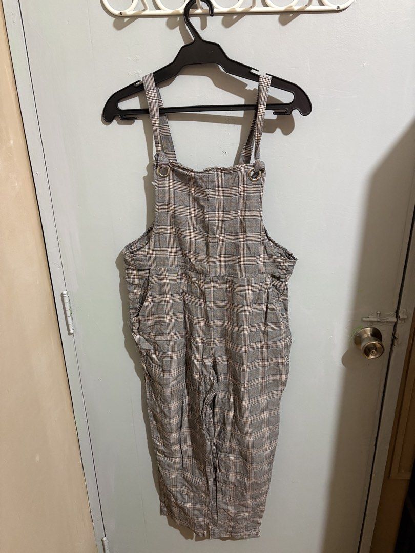 H&M Divided Grey Plaid Pinafore Jumpsuit (Category: Jumpsuits) located in Manila. Submitted by margascloset_ (Listing ID 1467305958, Image 1). Description: H&M Divided Plaid Pinafore Jumpsuit - Color/Pattern: Grey with brown and white check - Size: S - EUR 36P / UK 8P / CN 155/68A (Petite) - Features: Adjustable button straps (straps can be adjusted by both tying a knot) and two functional side pockets - Ideal for layering over tees or turtleneck