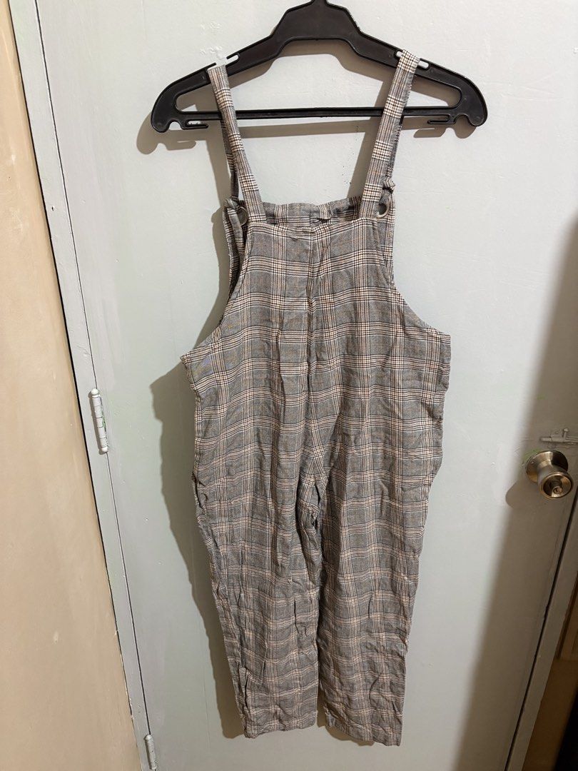 H&M Divided Grey Plaid Pinafore Jumpsuit (Category: Jumpsuits) located in Manila. Submitted by margascloset_ (Listing ID 1467305958, Image 2). Description: H&M Divided Plaid Pinafore Jumpsuit - Color/Pattern: Grey with brown and white check - Size: S - EUR 36P / UK 8P / CN 155/68A (Petite) - Features: Adjustable button straps (straps can be adjusted by both tying a knot) and two functional side pockets - Ideal for layering over tees or turtleneck