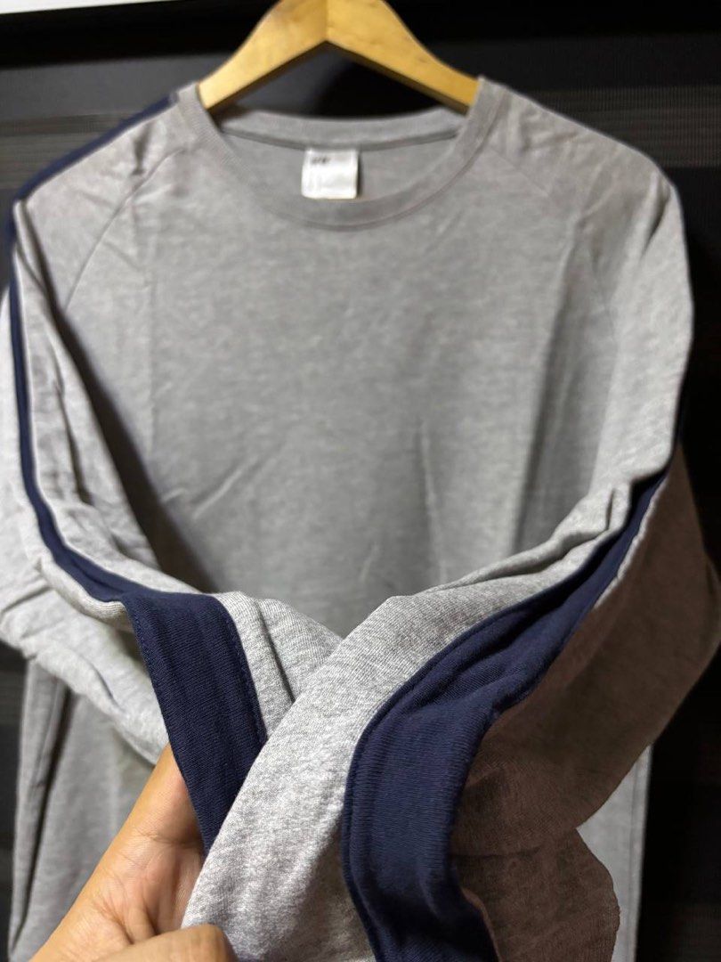 H&M Grey Sweatshirt with Navy Side Stripes (Category: Coats, Jackets and Outerwear) located in Pasig City. Submitted by abogadosupremo (Listing ID 1467347246, Image 3). Description: - H&M Grey Long-Sleeved Sweatshirt - Design: Navy blue stripes down the sleeves - Sleeves: Raglan style for comfort - Neckline: Crew neck - Style: Ideal for casual outfits or layering - 100% Legit and Authentic - Very Good Condition - Color may vary due to lighting - 