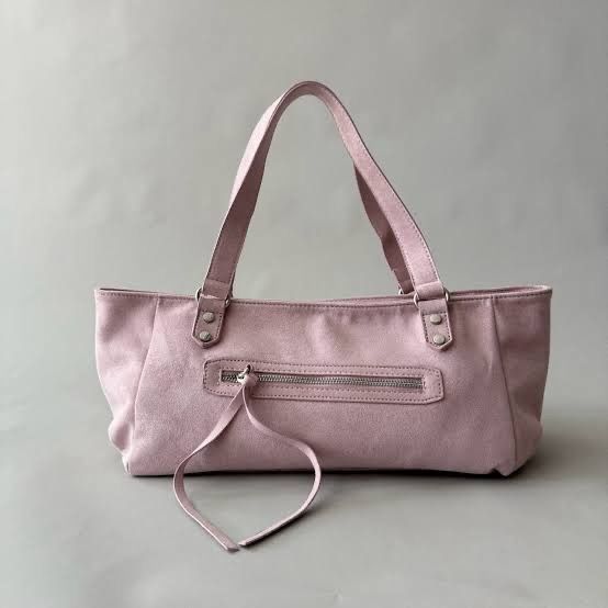 HOLB Sassy Bag in Suede Pink (Category: Tote Bags) located in Valenzuela. Submitted by raquesells (Listing ID 1467342734, Image 1). Description: - Color: Soft light pink - Material: Suede - Straps: Dual shoulder straps with silver rivet details - Pockets: Horizontal front pocket with metal zipper and long leather pull cords - Design: Long rectangular shape with clean stitching and a spacious main compartment - Style: Minimalist and trendy pastel 