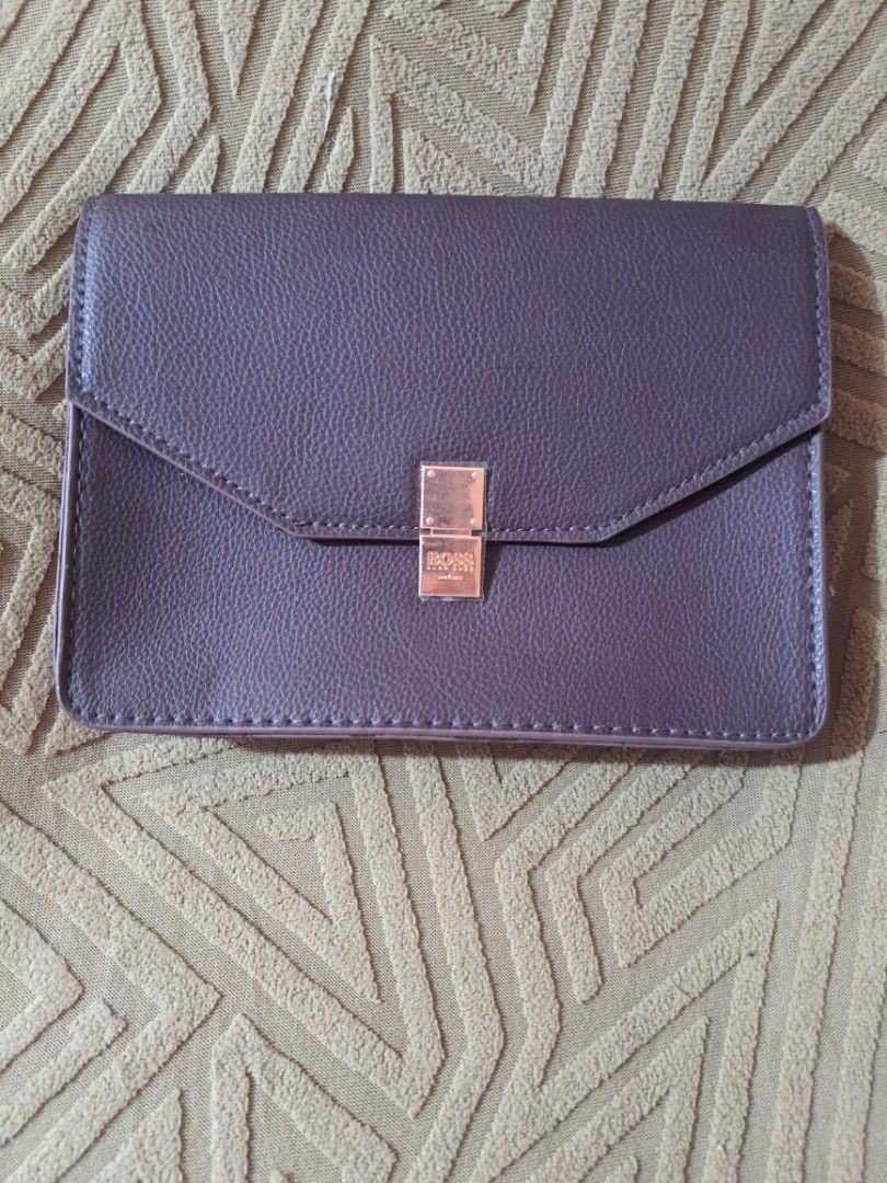 HUGO BOSS Parfums POUCH/BELT POUCH (Category: Luxury Bags & Wallets) located in Pasig City. Submitted by aecollection03 (Listing ID 1467172382, Image 2). Description: -Dimensions- -7"W-5"H-1¼"B inches - Brand: BOSS Parfums - Item: Dark purple faux leather agenda / organizer - Hardware: Rose gold metal clasp with embossed logo (protective plastic film still attached) - Interior: Purple fabric lining - Exterior: Back strap detail with a snap button