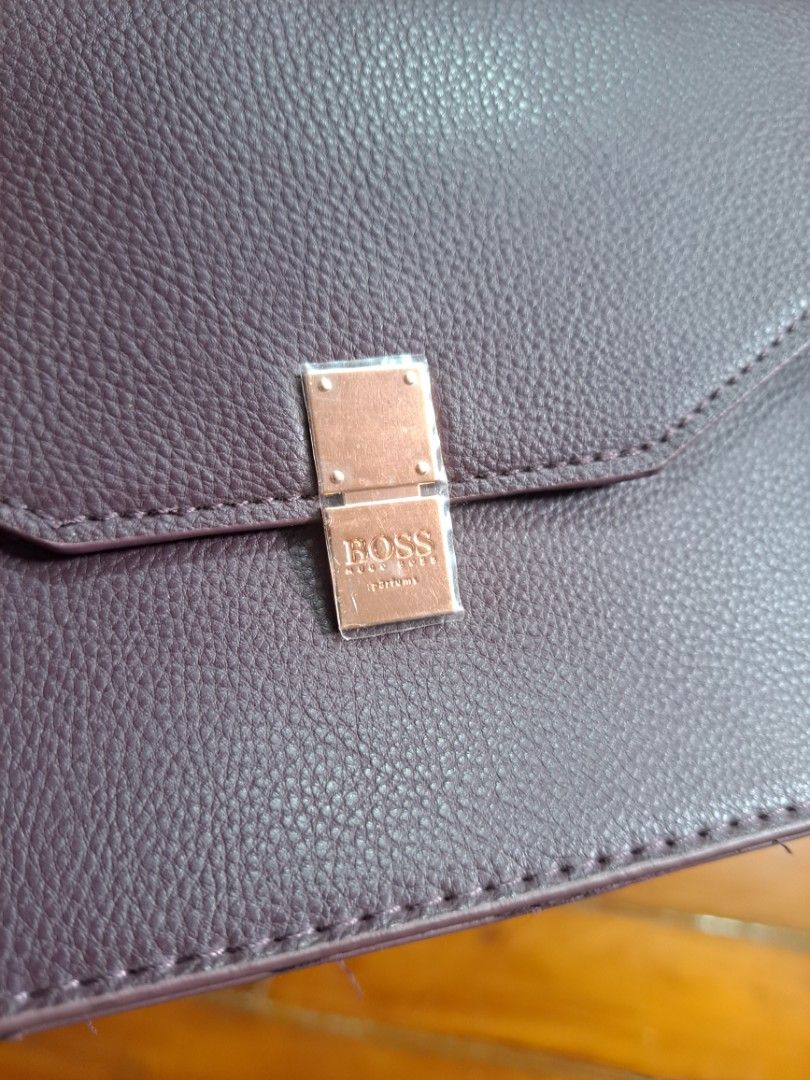 HUGO BOSS Parfums POUCH/BELT POUCH (Category: Luxury Bags & Wallets) located in Pasig City. Submitted by aecollection03 (Listing ID 1467172382, Image 1). Description: -Dimensions- -7"W-5"H-1¼"B inches - Brand: BOSS Parfums - Item: Dark purple faux leather agenda / organizer - Hardware: Rose gold metal clasp with embossed logo (protective plastic film still attached) - Interior: Purple fabric lining - Exterior: Back strap detail with a snap button