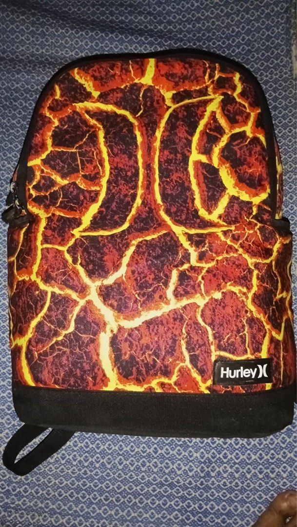 Hurley Lava Print Backpack (Category: Backpacks) located in Manila. Submitted by fleis.it (Listing ID 1467324460, Image 1). Description: Hurley backpack with a bright lava and magma crackle print. Black mesh back panel and matching black shoulder straps. Durable polyester material made in Cambodia. Standard O/S size. Great statement piece for school, travel, or everyday carry. Clean design with front label patch..