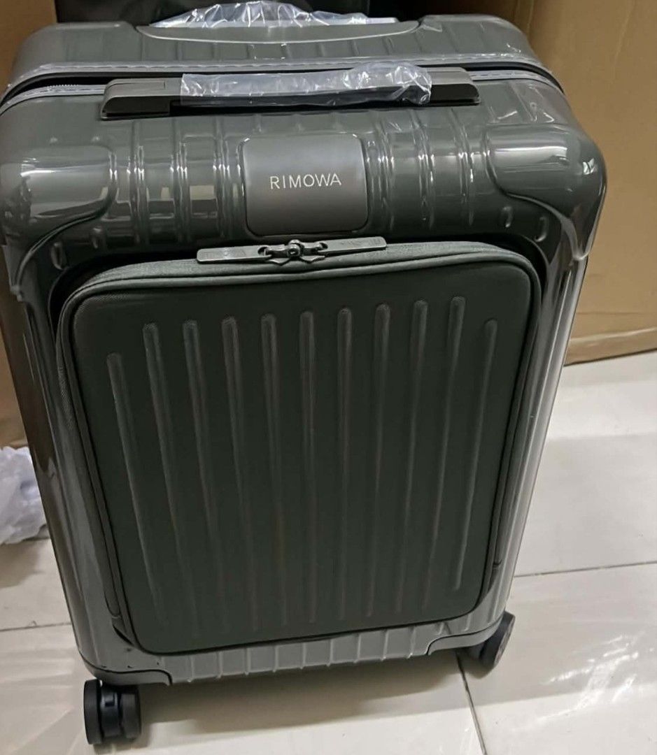 Hybrid Cabin Suitcase (Category: Luggage) located in Manila. Submitted by dh3nz1 (Listing ID 1467171385, Image 1). Description: - Brand: Rimowa Hybrid - Color: Olive green with dark hardware - Material: Durable hard-sided polycarbonate shell - Special Feature: Handy front pocket compartment for easy access - Mobility: Smooth spinner wheels and telescopic handle mechanism - Condition: Brand new, plastic wrap still intact on top handle and zipper p