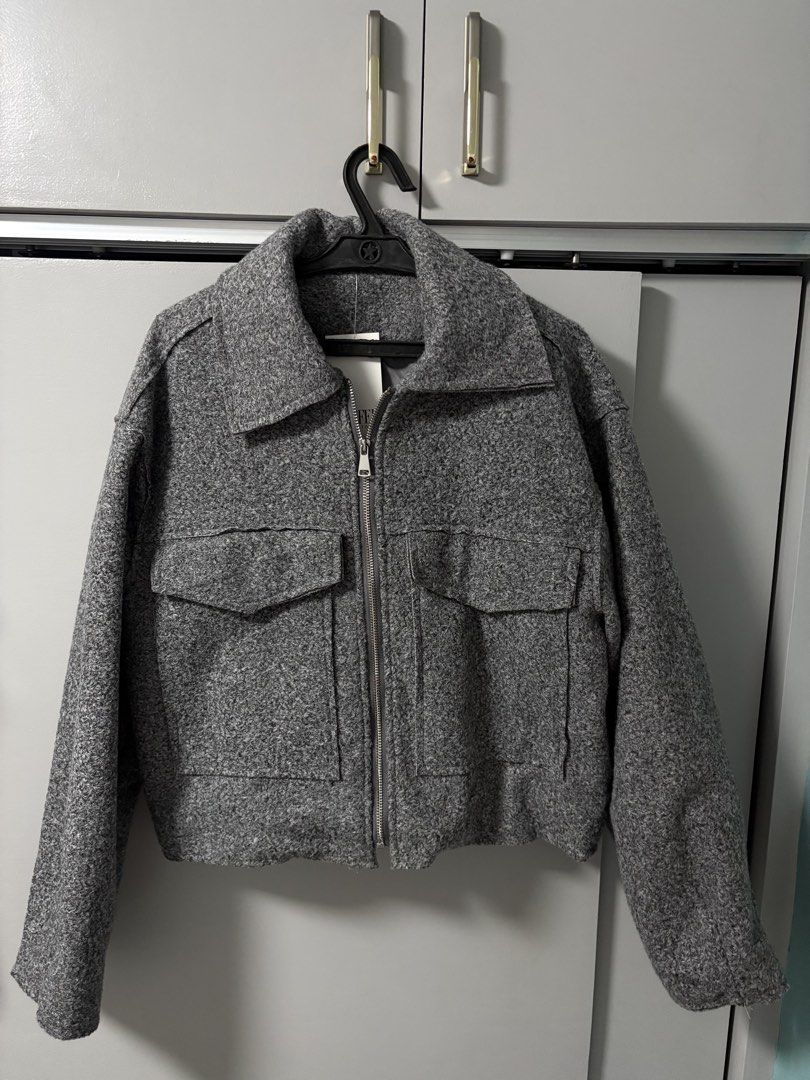 Indefeir Studios Grey Textured Zip Jacket (Category: Coats, Jackets and Outerwear) located in Imus. Submitted by _monicakes (Listing ID 1467168493, Image 1). Description: - Brand: Indefeir Studios - Condition: Brand new with tags (never worn) - Color: Grey - Material: Textured fleece / wool-like exterior - Features: Full front zipper, pointed collar, and two large chest pockets with flaps - Detail: Unique brand tag on the zipper pull.