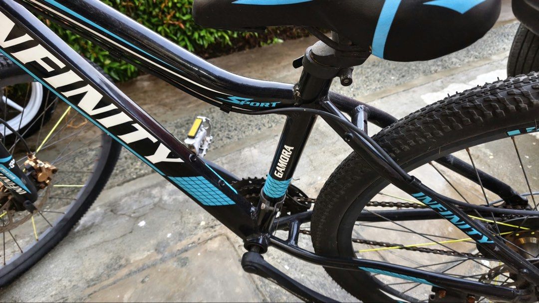 Infinity Gamora Mountain Bike (Category: Bicycles) located in Manila. Submitted by themb (Listing ID 1467211815, Image 2). Description: - Brand/Model: Infinity Gamora Mountain Bike - Colorway: Black and Blue - Wheel Size: 26 inches - Speeds: 24-speed setup with Shimano Altus components - Components: Infinity branded saddle and attached kickstand - Condition Details: Frame shows normal riding wear, gears and brakes require tune-up, and suspension 