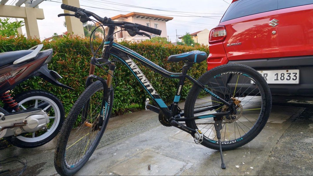 Infinity Gamora Mountain Bike (Category: Bicycles) located in Manila. Submitted by themb (Listing ID 1467211815, Image 1). Description: - Brand/Model: Infinity Gamora Mountain Bike - Colorway: Black and Blue - Wheel Size: 26 inches - Speeds: 24-speed setup with Shimano Altus components - Components: Infinity branded saddle and attached kickstand - Condition Details: Frame shows normal riding wear, gears and brakes require tune-up, and suspension 