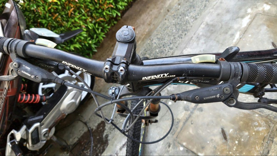 Infinity Gamora Mountain Bike (Category: Bicycles) located in Manila. Submitted by themb (Listing ID 1467211815, Image 3). Description: - Brand/Model: Infinity Gamora Mountain Bike - Colorway: Black and Blue - Wheel Size: 26 inches - Speeds: 24-speed setup with Shimano Altus components - Components: Infinity branded saddle and attached kickstand - Condition Details: Frame shows normal riding wear, gears and brakes require tune-up, and suspension 