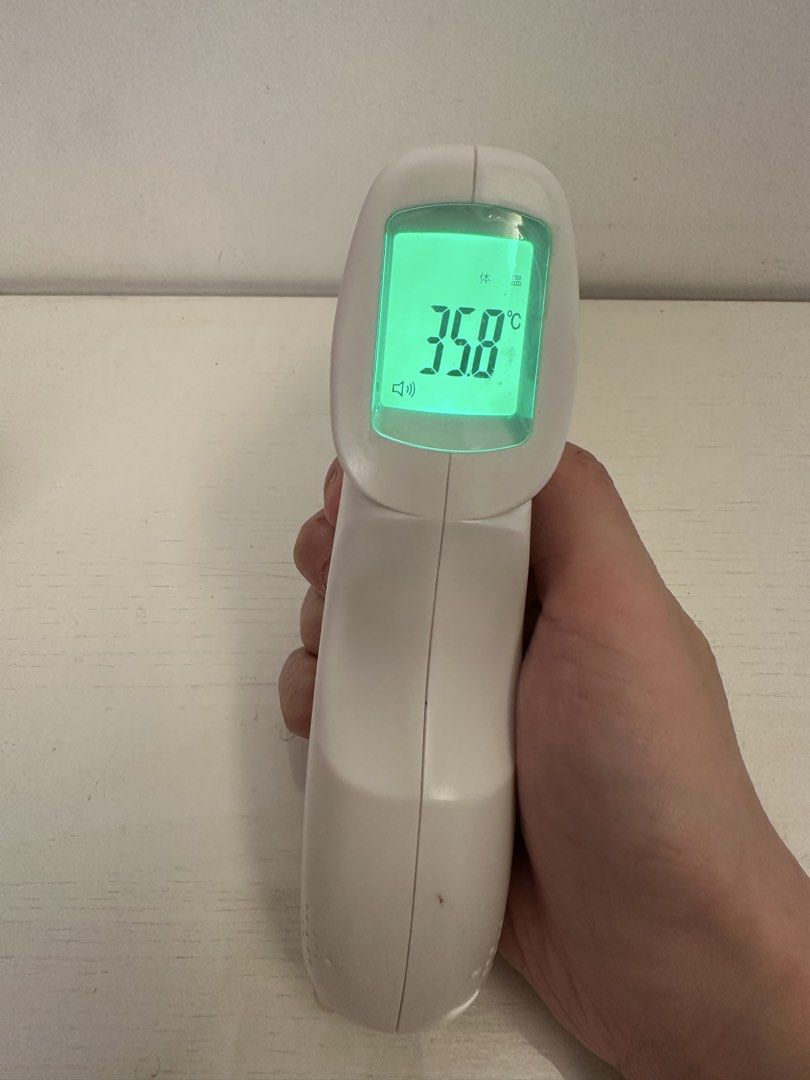 Infrared Body Thermometer (Category: Thermometers) located in Quezon City. Submitted by bqchane (Listing ID 1467262098, Image 2). Description: - Model: Berrcom JKB-17B Non-Contact Infrared Thermometer - Condition: Tested and fully working with minor handling marks - Display: Clear green backlit digital screen for easy reading - Features: Mode, sound, and memory control buttons - Design: Clean white body with a blue control panel - Power: Requires