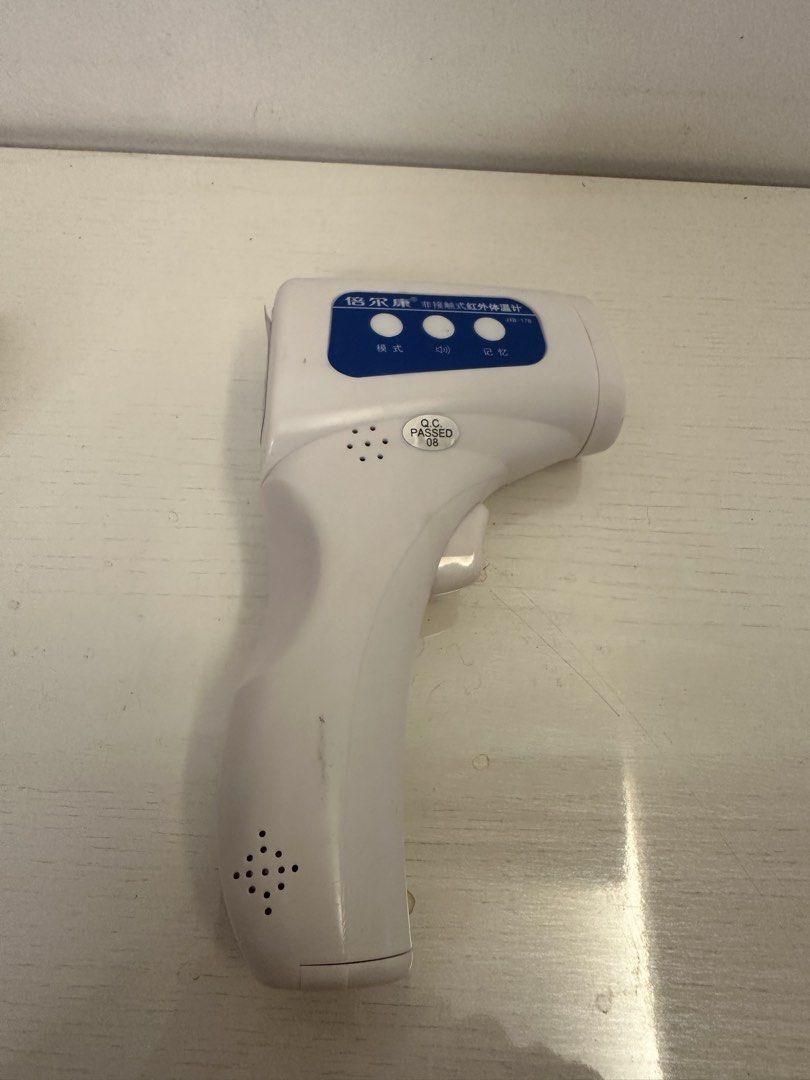 Infrared Body Thermometer (Category: Thermometers) located in Quezon City. Submitted by bqchane (Listing ID 1467262098, Image 1). Description: - Model: Berrcom JKB-17B Non-Contact Infrared Thermometer - Condition: Tested and fully working with minor handling marks - Display: Clear green backlit digital screen for easy reading - Features: Mode, sound, and memory control buttons - Design: Clean white body with a blue control panel - Power: Requires