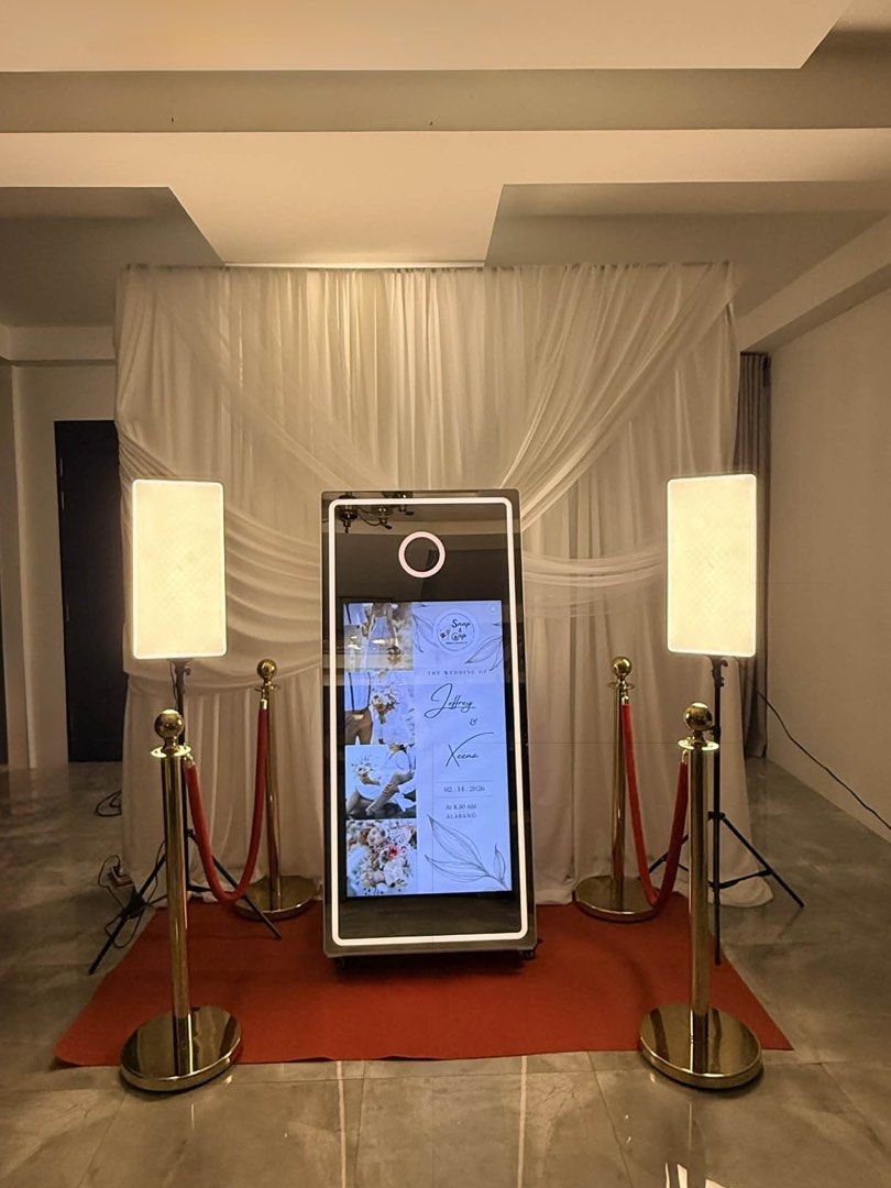 Interactive Digital Mirror Photo Booth with Lighting and Stanchions (Category: Cameras) located in Quezon City. Submitted by comeherenicole (Listing ID 1467198330, Image 1). Description: - Complete all-in-one photo booth setup for weddings, parties, and events - 65” digital touchscreen display with a built-in led light - Includes Hiti Printer 525L, 2 led lights, premium props (sintra boards, headbands, shades), Photo standee and magnet (4R and st