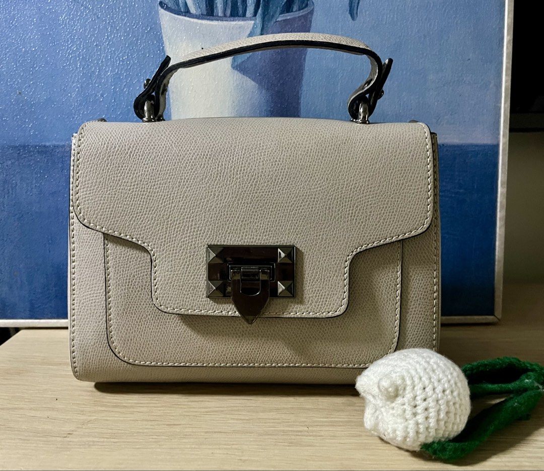 Italian Brand top handle bag (Category: Cross-body Bags) located in Quezon City. Submitted by madshoppe (Listing ID 1467258382, Image 1). Description: Like except for inside flap’s signs of use, not visible when closed see last 2 photos Very pretty taupe or apricot color and gunmetal hardwares With sling Small .