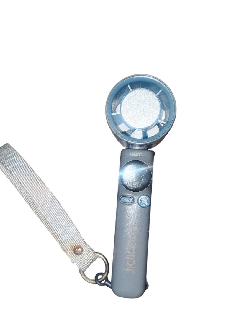 Jiditech Handheld Electric Fan JD-SS026 with Box (Category: Fans) located in Manila. Submitted by harpercbrr36253 (Listing ID 1467276762, Image 2). Description: - BAWAL SA MAARTE, SELLING IT AS IS - Model: Jiditech JD-SS026 Handheld Turbine Fan - Color: Sleek grey and blue design - Condition: Tested and fully working - Power: Rechargeable battery-powered - Inclusion: Comes with original box and wrist lanyard strap - Perfect for daily commuting an