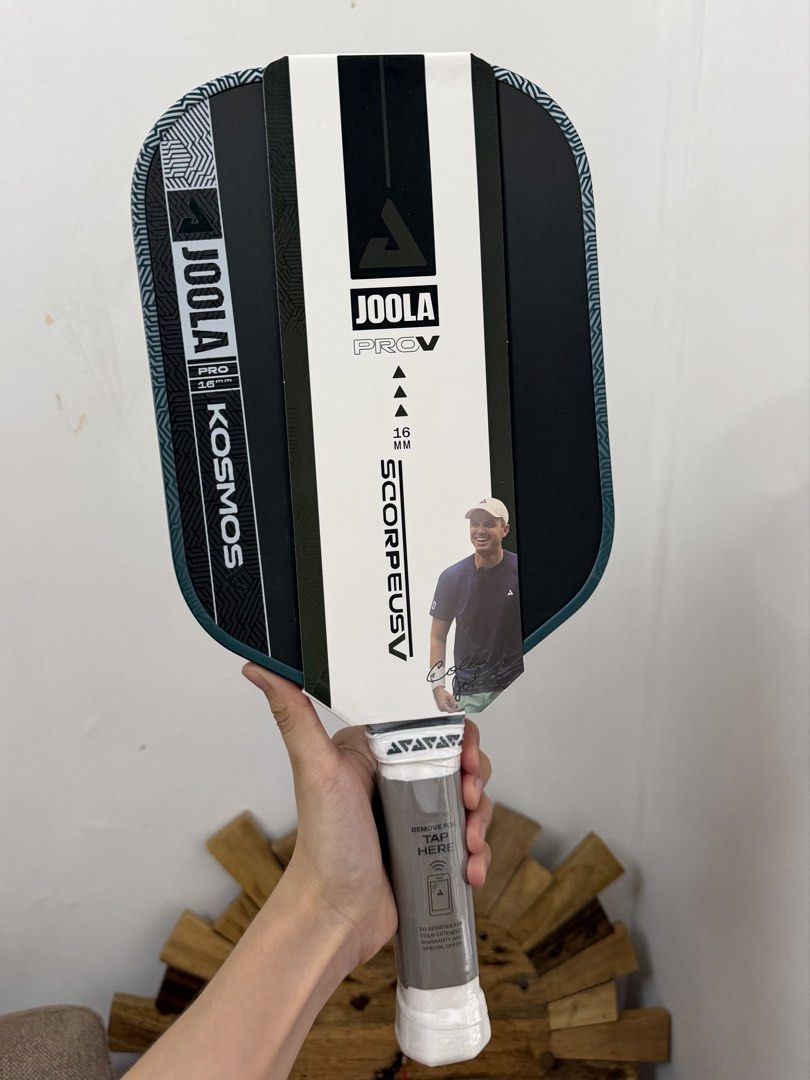 Joola Scorpeus Pro V (Category: Racket and Ball Sports) located in Cavite. Submitted by lovedbynics.official (Listing ID 1467273680, Image 1). Description: - Item: Joola Scorpeus Pro V Pickleball Paddle - Thickness: 16mm - Condition: Brand new, never used, straight out of the box - Packaging: Still wrapped in original plastic with promotional paper sleeve - Handle: White grip with protective film and warranty chip registration sticker on the base