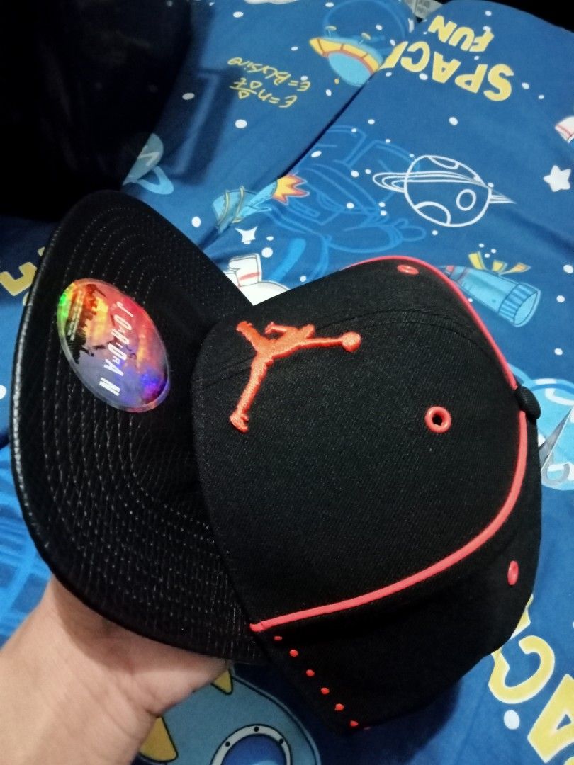 Jordan Jumpman Black and Red Flat Bill Cap (Category: Caps & Hats) located in Manila. Submitted by ryanjoseph94468 (Listing ID 1467244874, Image 2). Description: Black and red Jordan snapback cap with embroidered Jumpman logo on the front. Red piping along the seams and dotted pattern details on the side panels. Flat brim with holographic sticker on top. Original hang tags attached, featuring adult unisex sizing and retail price tag of thirty fiv