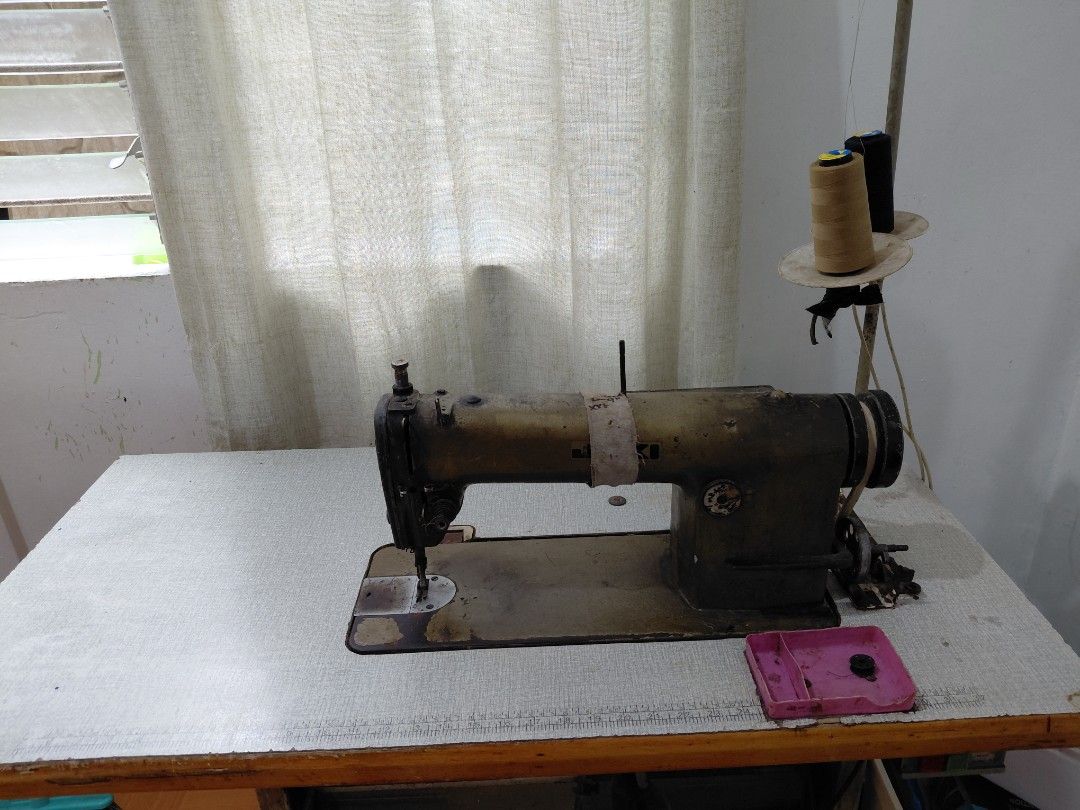 Juki industrial sewing machine with table and motor (Category: Industrial Equipment) located in Rizal. Submitted by maelynfernando (Listing ID 1467205457, Image 1). Description: Heavy-duty industrial sewing machine with table. Built with a solid cast iron body showing some wear and patina from use. Heavy setup, local pickup only. Location: Angono Rizal.