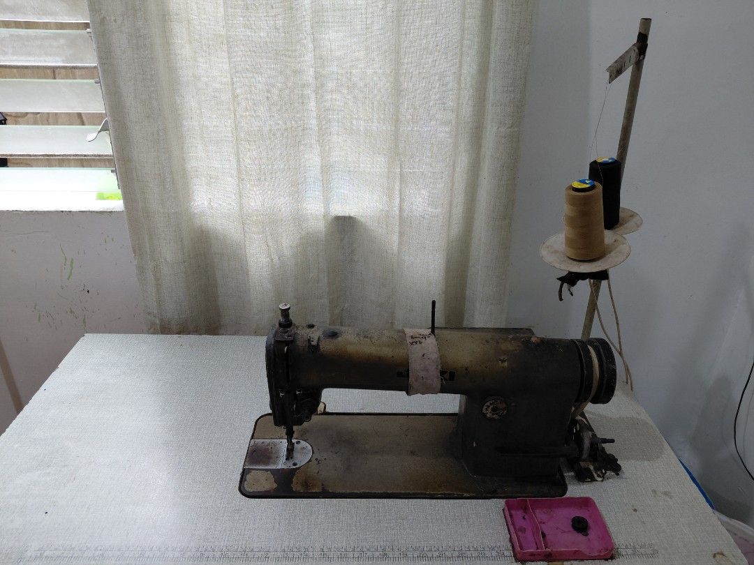 Juki industrial sewing machine with table and motor (Category: Industrial Equipment) located in Rizal. Submitted by maelynfernando (Listing ID 1467205457, Image 2). Description: Heavy-duty industrial sewing machine with table. Built with a solid cast iron body showing some wear and patina from use. Heavy setup, local pickup only. Location: Angono Rizal.