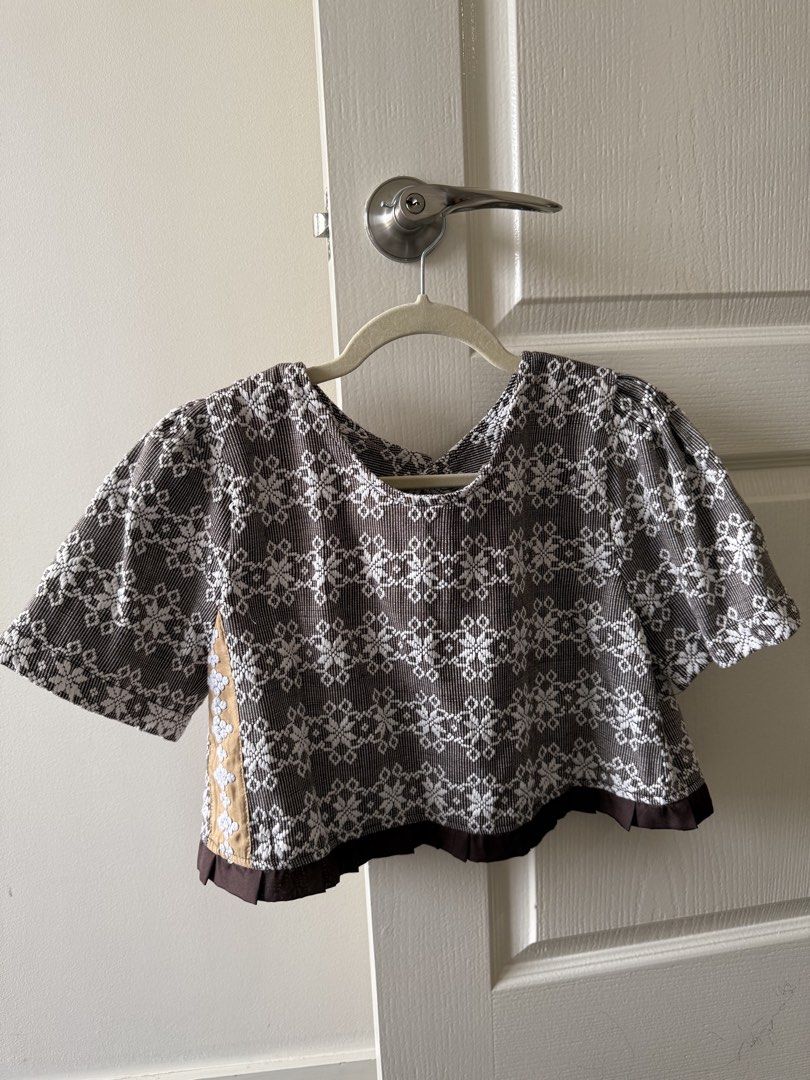Kaayo Modern Mindanao Mara Top (Category: Blouses) located in Taguig. Submitted by muntingkahon (Listing ID 1467193833, Image 1). Description: - Brand: Kaayo Modern Mindanao - Style: Brown and white woven crop blouse - Size: S (tag attached) - Details: Short puff sleeves, wooden-style front buttons, brown ruffled hem - Special Feature: Side panels with gold fabric and white decorative embroidery - Pattern: Traditional woven textile all over - Occ