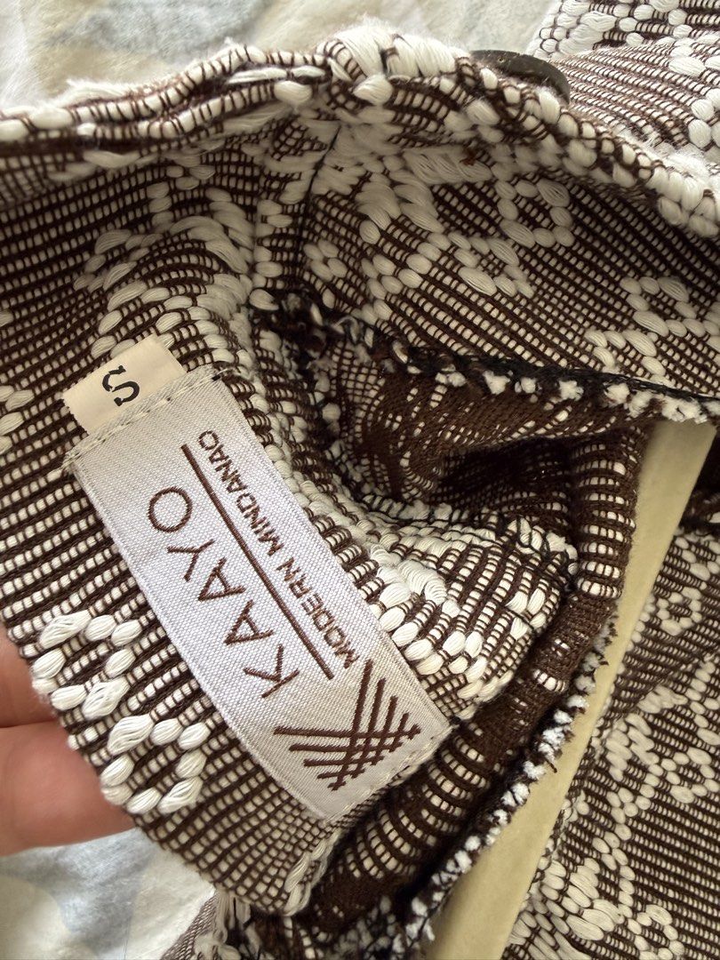 Kaayo Modern Mindanao Mara Top (Category: Blouses) located in Taguig. Submitted by muntingkahon (Listing ID 1467193833, Image 2). Description: - Brand: Kaayo Modern Mindanao - Style: Brown and white woven crop blouse - Size: S (tag attached) - Details: Short puff sleeves, wooden-style front buttons, brown ruffled hem - Special Feature: Side panels with gold fabric and white decorative embroidery - Pattern: Traditional woven textile all over - Occ