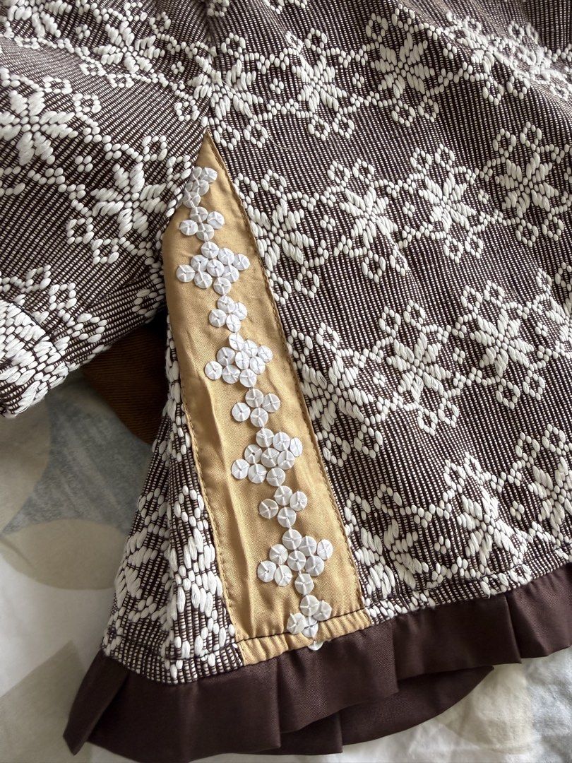 Kaayo Modern Mindanao Mara Top (Category: Blouses) located in Taguig. Submitted by muntingkahon (Listing ID 1467193833, Image 3). Description: - Brand: Kaayo Modern Mindanao - Style: Brown and white woven crop blouse - Size: S (tag attached) - Details: Short puff sleeves, wooden-style front buttons, brown ruffled hem - Special Feature: Side panels with gold fabric and white decorative embroidery - Pattern: Traditional woven textile all over - Occ
