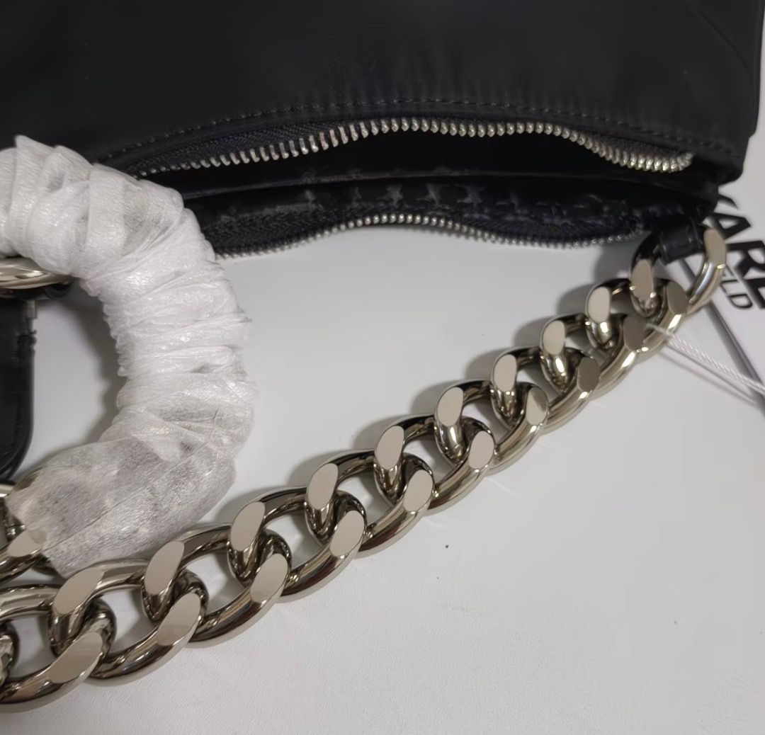 Karl Lagerfeld Black Nylon Chain Shoulder Bag (Category: Shoulder Bags) located in Pasay City. Submitted by kgemsluxuryboutique (Listing ID 1467352678, Image 3). Description: - Brand: Karl Lagerfeld - Material: Durable black nylon - Design: Front graphic featuring Karl Lagerfeld and Choupette - Hardware & Straps: Chunky silver-tone chain strap - Compartments: Dual zipped compartments with branded lining - Condition: Brand new with tags attached -