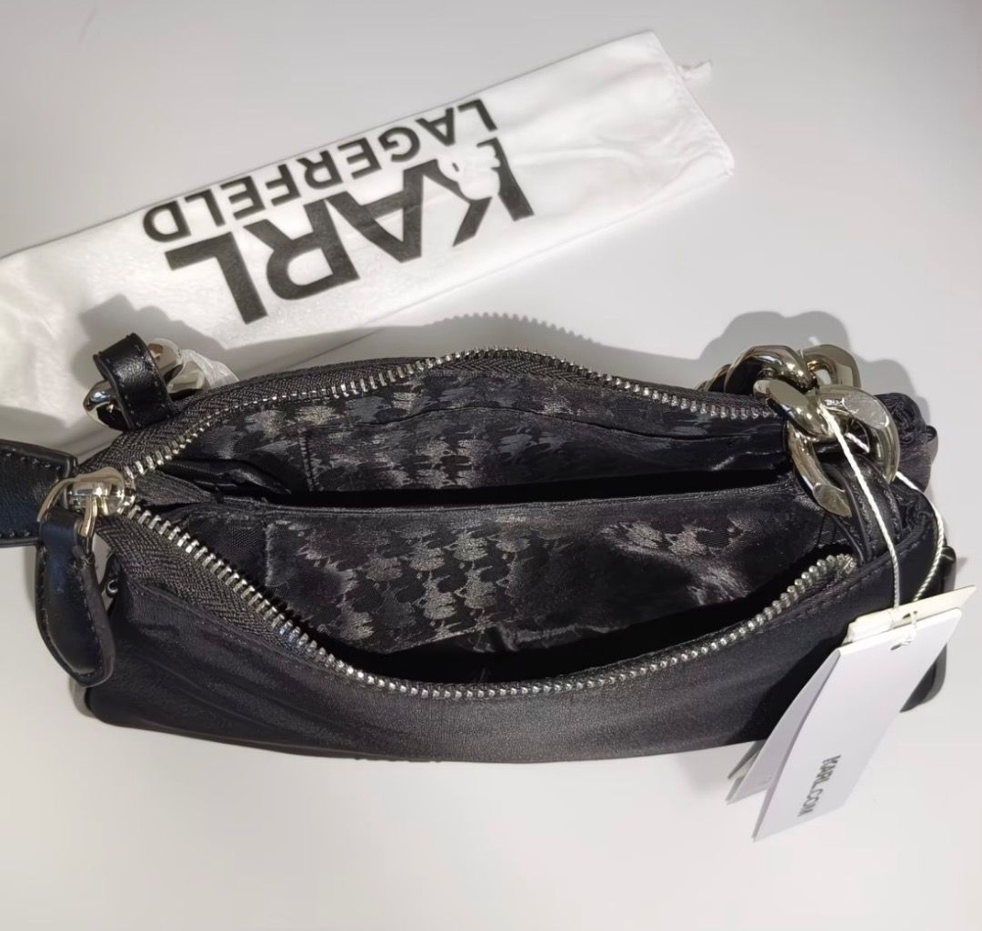 Karl Lagerfeld Black Nylon Chain Shoulder Bag (Category: Shoulder Bags) located in Pasay City. Submitted by kgemsluxuryboutique (Listing ID 1467352678, Image 2). Description: - Brand: Karl Lagerfeld - Material: Durable black nylon - Design: Front graphic featuring Karl Lagerfeld and Choupette - Hardware & Straps: Chunky silver-tone chain strap - Compartments: Dual zipped compartments with branded lining - Condition: Brand new with tags attached -