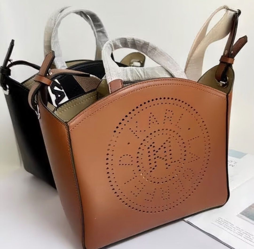 Karl Lagerfeld Perforated Logo Tote Bag (Category: Tote Bags) located in Pasay City. Submitted by kgemsluxuryboutique (Listing ID 1467332642, Image 3). Description: - Brand: Karl Lagerfeld - Design: Cut-out circular logo on front with a structured silhouette - Colors Available: Black and Brown - Carry Options: Two top handles and a wide canvas shoulder strap with bold lettering - Closure: Open top design - Capacity: Spacious interior, perfect for