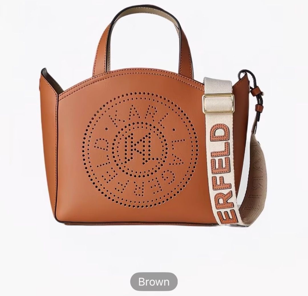 Karl Lagerfeld Perforated Logo Tote Bag (Category: Tote Bags) located in Pasay City. Submitted by kgemsluxuryboutique (Listing ID 1467332642, Image 2). Description: - Brand: Karl Lagerfeld - Design: Cut-out circular logo on front with a structured silhouette - Colors Available: Black and Brown - Carry Options: Two top handles and a wide canvas shoulder strap with bold lettering - Closure: Open top design - Capacity: Spacious interior, perfect for