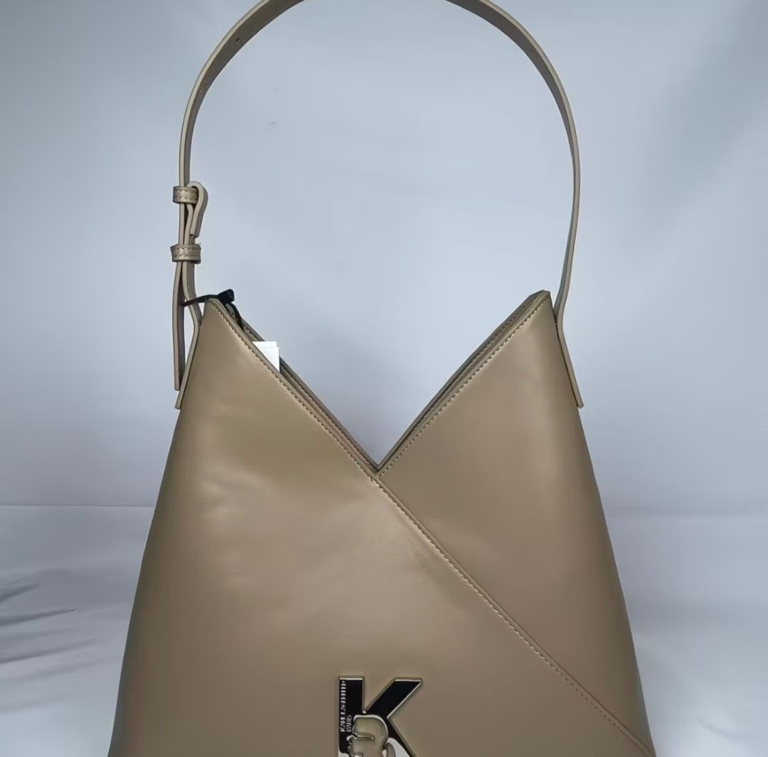 Karl Lagerfeld tote (Category: Shoulder Bags) located in Pasay City. Submitted by kgemsluxuryboutique (Listing ID 1467235423, Image 3). Description: - Trendy V-shaped triangle hobo design - Features stylish silver-tone K logo hardware - Adjustable shoulder strap for comfortable wear - Roomy interior with patterned fabric lining and convenient side pocket - Secure top zip closure - Dimensions: 32 x 19 x 9 cm - Available colors: Black and Khaki Res