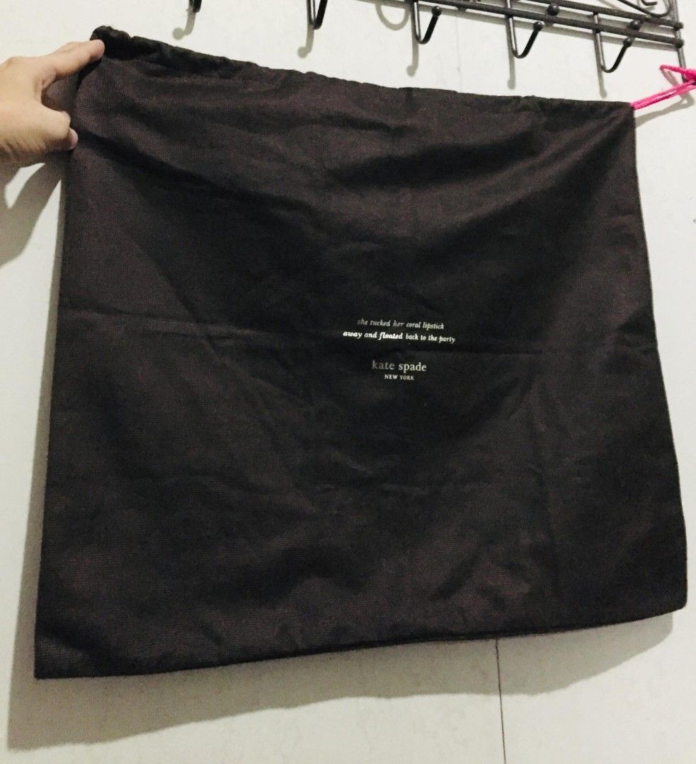Kate Spade New York Dust Bag (Category: Tote Bags) located in Batangas. Submitted by fabufindsstore. (Listing ID 1467290284, Image 1). Description: Authentic Kate Spade dust bag Quality material Features a chic printed quote ("she tucked her coral lipstick away and floated back to the party") with the brand logo underneath Soft fabric material protects your bags from dust and scratches Secure and convenient drawstring top closure 490 only Mode of