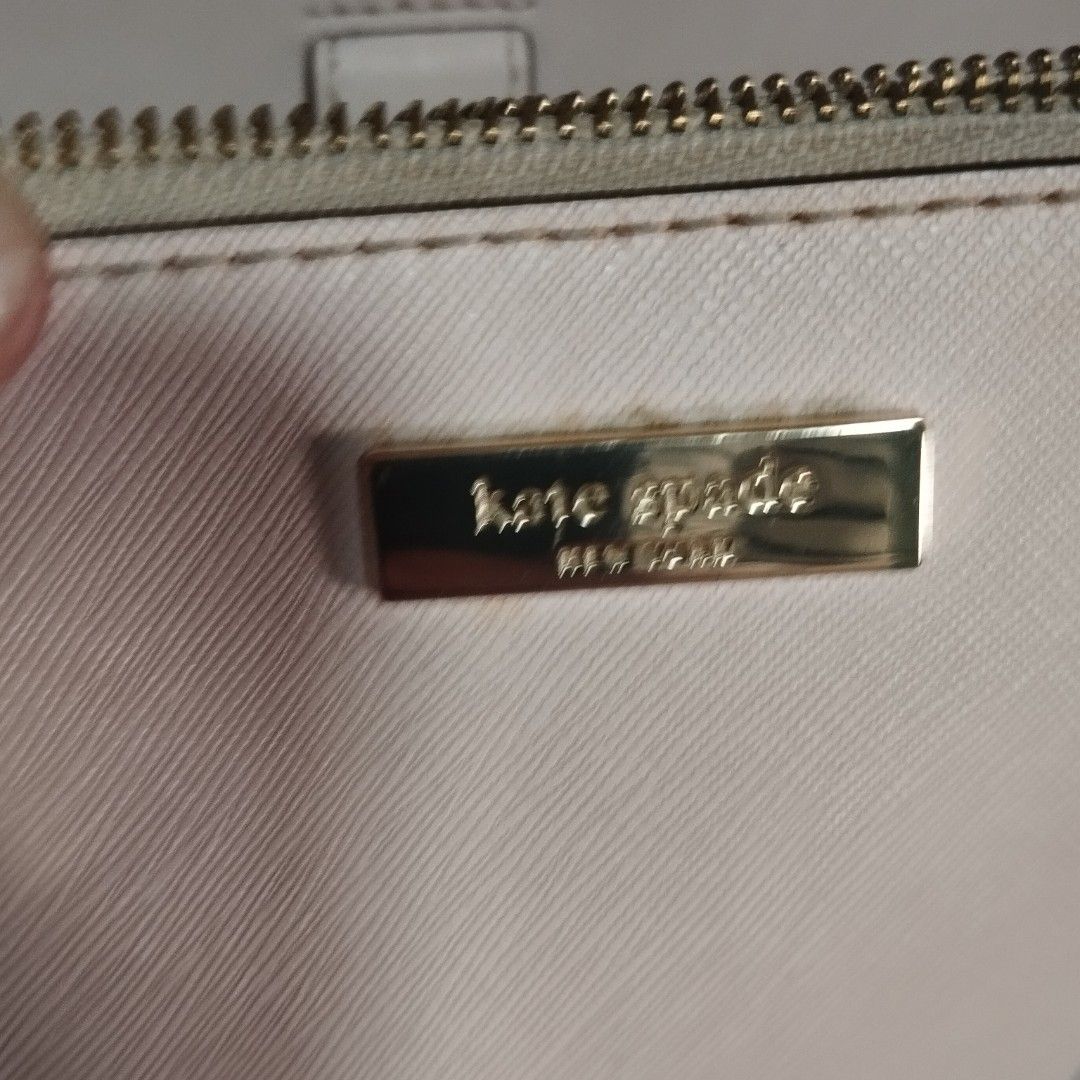 Kate Spade Pink Leather Handbag (Category: Shoulder Bags) located in Manila. Submitted by lene48 (Listing ID 1467171313, Image 3). Description: - Brand: Kate Spade - Color: Pale pink with gold-tone hardware - Material: Durable structured Saffiano leather - Compartments: Double zipped main compartments - Handles: Rolled top handles for comfortable carrying - Interior: Classic black and white patterned lining (Note: has some minor staining inside) 
