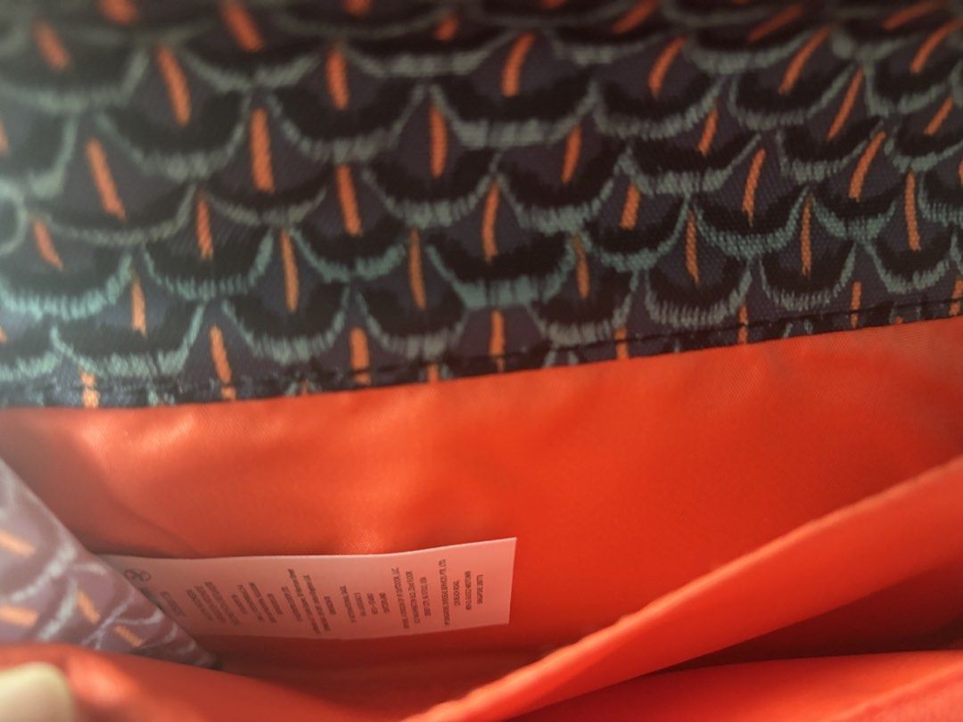 Kipling (Category: Wallets & Card Holders) located in Singapore. Submitted by vbuibui (Listing ID 1467262120, Image 5). Description: - Brand: Kipling ( Belgium) - Design: Dark patterned exterior with geometric motif and striking orange inner lining - Closure: Secure double snap-button flap - Compartments: Multiple card slots, cash compartments, and a clear ID window - bought when travelling overseas. - Condition: brand new Retail selling more tha