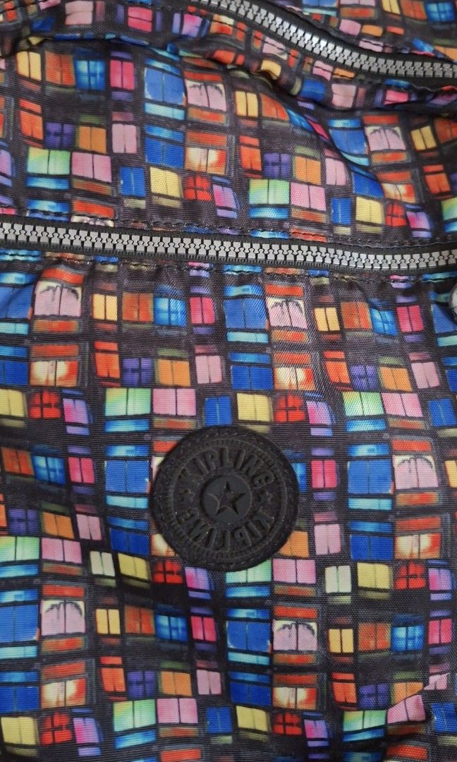 Kipling Backpack (Category: Backpacks) located in Manila. Submitted by thrifter_lifestyle (Listing ID 1467170778, Image 3). Description: Brand: Kipling (bought in US) Geometrical Design 2 level compartment, back has padded laptop sleeve (see photo) Multiple zipped pockets in front, lots of storage With Kipling logo in front and monkey key chain Adjustable padded straps H: 16.5" W: 5.5" L: 13" Minimal signs of usage in zipper and handle up top. rf