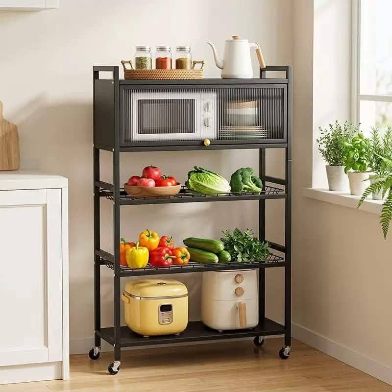 Kitchen rolling storage rack with cabinet and wheels (Category: Shelves, Cabinets & Racks) located in Caloocan City. Submitted by swiftflower_802790 (Listing ID 1467217195, Image 3). Description: - Color: Sleek black multi-tier design - Storage: Includes a lockable cabinet top, two wire baskets, and a bottom shelf - Dimensions: 78cm wide x 31cm deep x 125cm tall - Mobility: Equipped with rolling caster wheels for easy movement - Ideal For: Organi