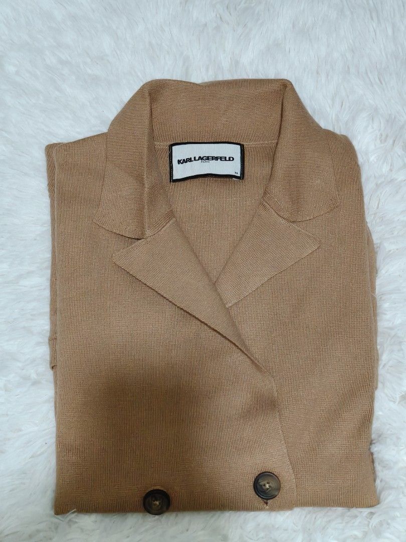 Knitted Vest Cardigan (Category: Coats, Jackets and Outerwear) located in Makati City. Submitted by la_storeph (Listing ID 1467319008, Image 1). Description: - Brand: Karl Lagerfeld Paris - Style: Knit cardigan with lapel collar and double-breasted tortoiseshell button front - Color: Camel brown - Size: Free size - Material: Fine-knit fabric texture - Condition: Excellent, clean presentation.